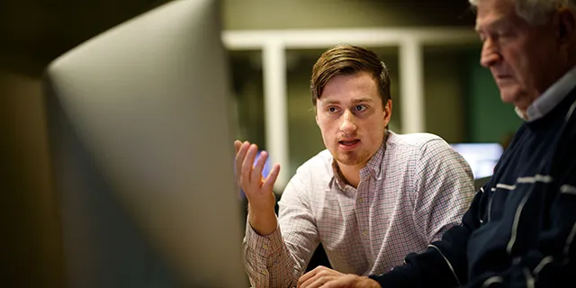 Master of accounting students analyzing financial reports in a modern university classroom