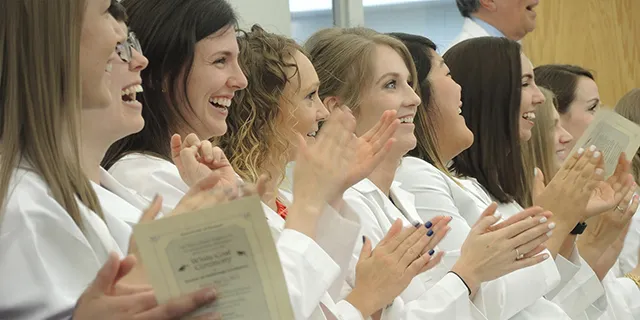 Doctor of audiology students at KU celebrating at the annual white coat ceremony