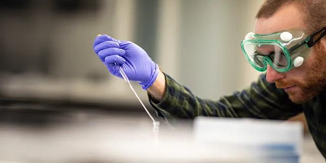 Bioengineering masters student testing medical devices in a University of Kansas biomedical lab