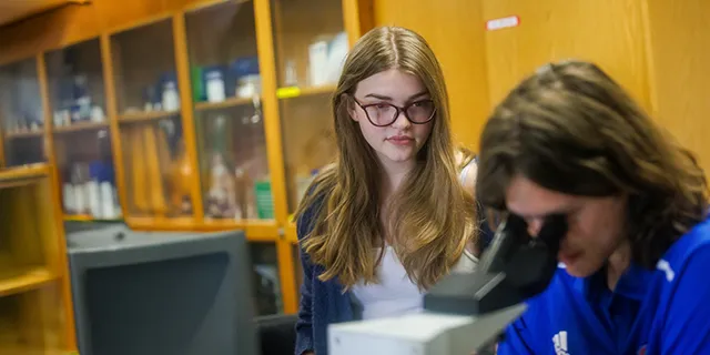 KU biotechnology degree student working with faculty in the lab