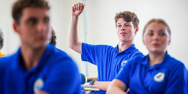 Business administration degree students engaged in conversation during class