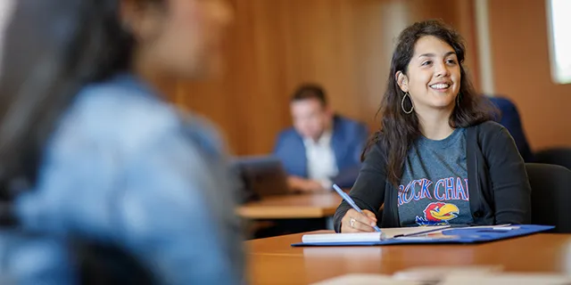 Business analytics degree student analyzing business data during class at KU