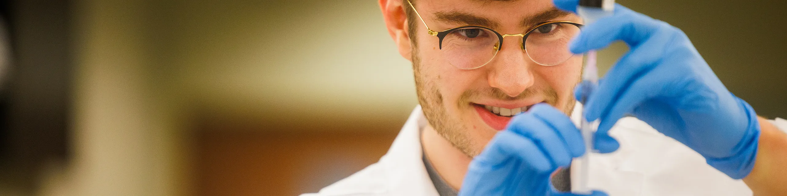 Graduate students analyzing cancer cell cultures in a university of Kansas oncology research lab