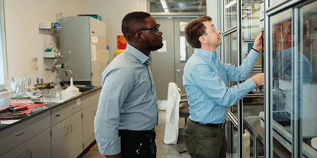 Doctor of chemical and petroleum engineering students at KU modeling reservoir flow in a chemical and petroleum engineering research lab