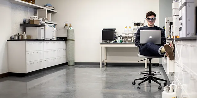 Master of chemistry student conducting experiments in a modern university of Kansas research laboratory