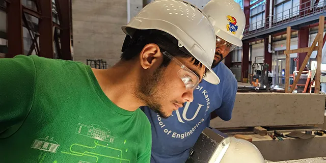 Doctor of civil engineering students at KU testing structural models under seismic loads in a civil engineering lab