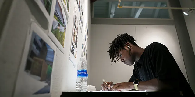 University of Kansas Master of Classics student examining ancient Greek and Roman artifacts