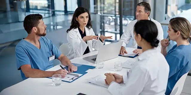 Master of clinical research students reviewing clinical trial protocols in a university of Kansas research coordination lab