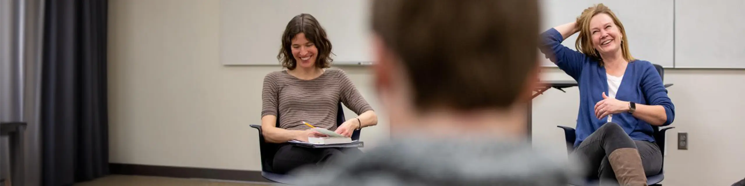 Doctor of counseling psychology students at KU facilitating a large counseling session in a psychology clinic