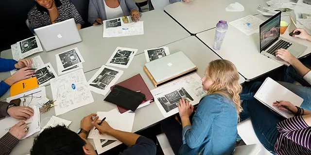 Master of design management students brainstorming design management strategies in a modern university studio