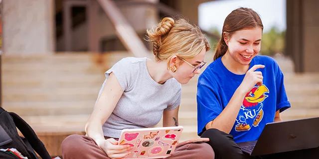 University of Kansas elementary education students discussing a project on KU's campus
