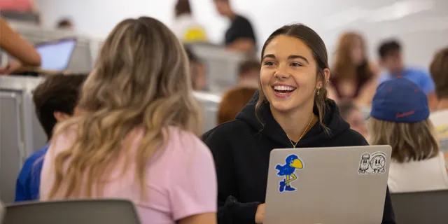 KU students participate in classroom discussion and academic collaboration as part of a master's in English program.