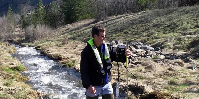 Environmental geology masters faculty member conducting research in the field