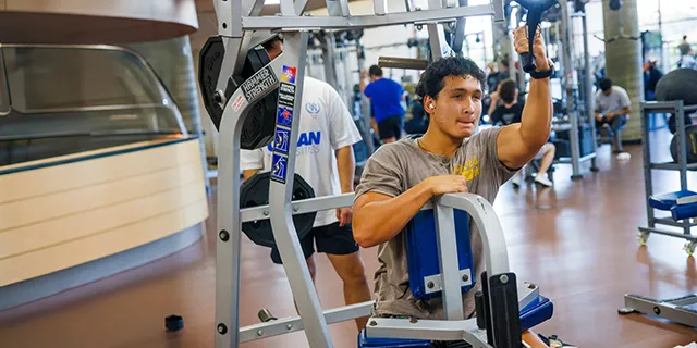KU exercise science degree student working out in the KU gym