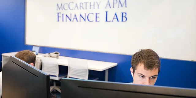 University of Kansas finance degree students analyzing markets in finance classroom