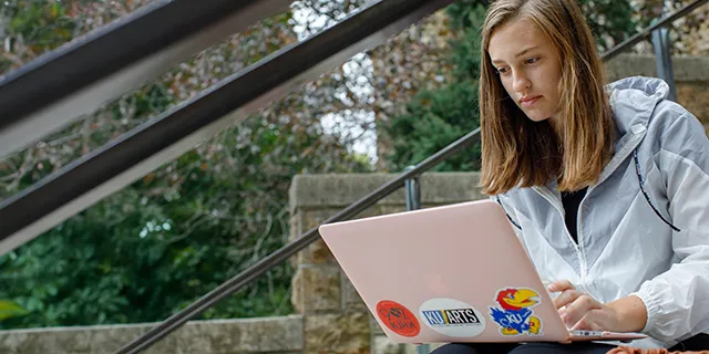 Master of global and international studies student reviewing global issues on KU's campus