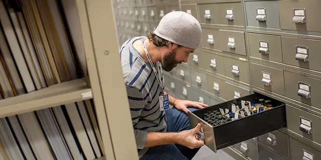 History doctoral students examining historical documents in the university of Kansas archive room