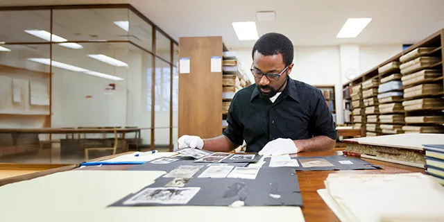 Masters of history student examining historical documents in the university of Kansas archive room