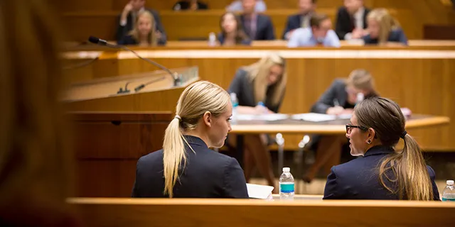 Juris doctor students in KU arguing a mock trial in a law school courtroom