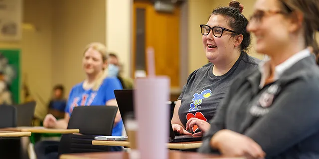 University of Kansas mathematics degree students solving equations in mathematics classroom