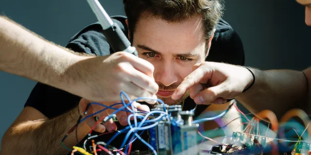 Master of mechanical engineering students at KU testing robotic prototypes in a mechanical engineering lab