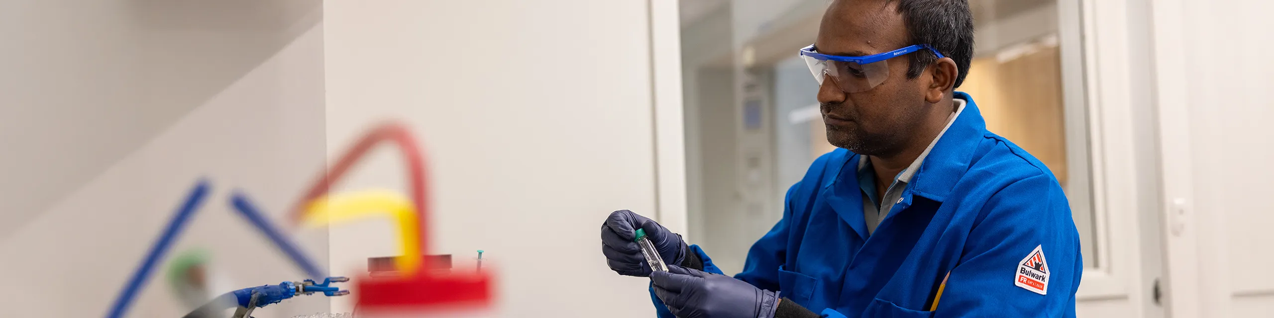 Doctor of medicinal chemistry student at KU synthesizing compounds in a medicinal chemistry research lab