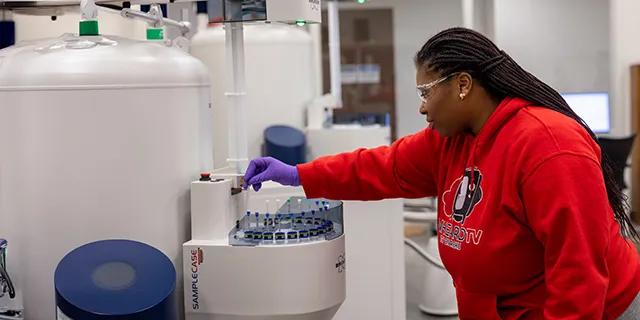 Master of medicinal chemistry student at KU synthesizing compounds in a medicinal chemistry research lab
