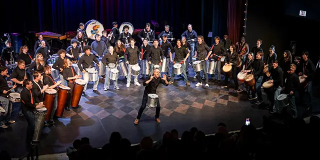 Doctor of Music students rehearsing in a university of Kansas ensemble hall with instruments