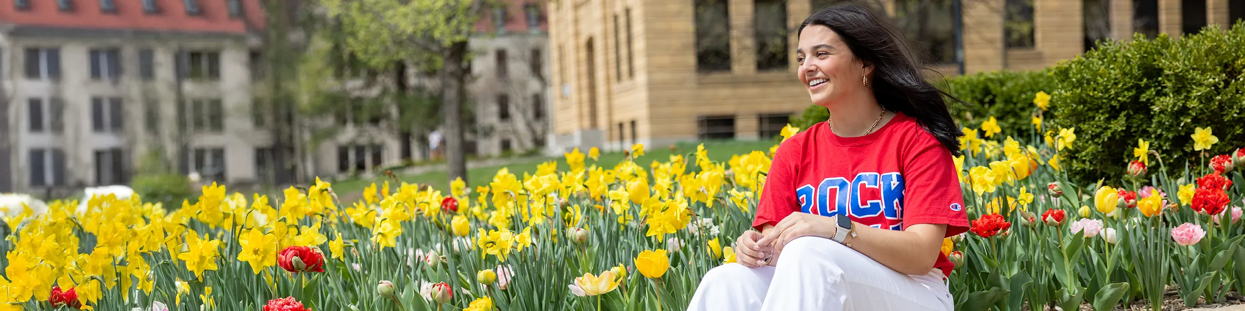 University of Kansas music education degree student posing for a photo by a field of flowers