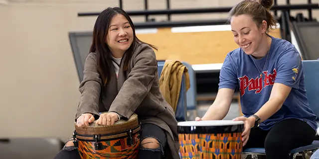 Graduate music student practicing the cello on campus