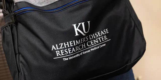 A shoulder bag branded with the KU Alzheimer's Disease Research Center logo at the University of Kansas Medical Center.