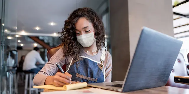 Doctor of nurse anesthesia practice student at KU reviewing intubation procedures on a laptop