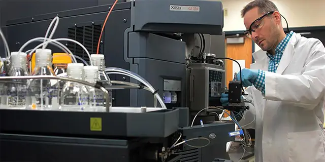 Doctor of pharmaceutical chemistry student at KU conducting drug synthesis in a pharmaceutical chemistry lab