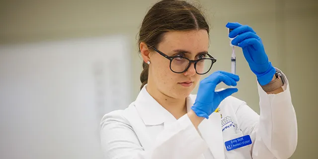 University of Kansas students researching drugs in pharmaceutical studies lab