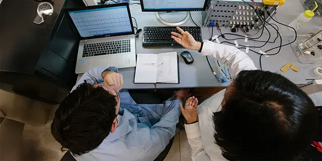 Doctor of pharmacaology students at KU testing drug effects on cellular models in a pharmacology lab