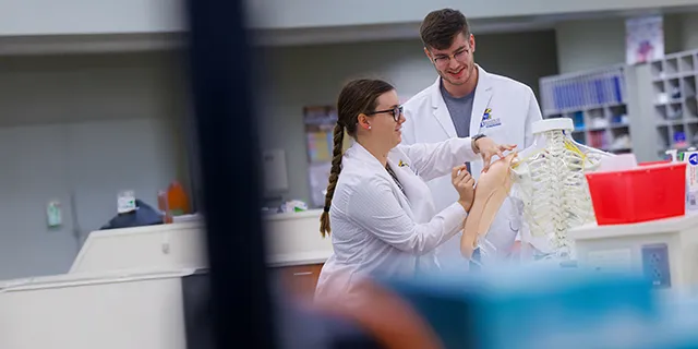 Masters pharmacy students at KU working in a pharmacy practice lab
