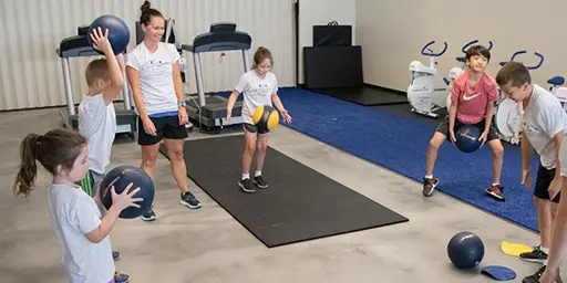 University of Kansas physical education degree students coaching in physical education gym