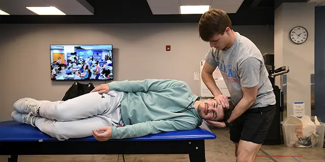 Doctor of physical therapy students at KU assessing patient movement in a physical therapy lab