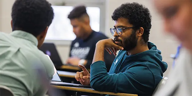 Public administration masters students reviewing the day's lecture
