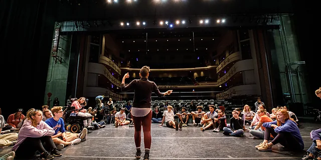 KU students participate in a stage rehearsal inside at the Lied Center of Kansas, gaining practical experience in acting, performance, and production as part of the musical theatre degree.