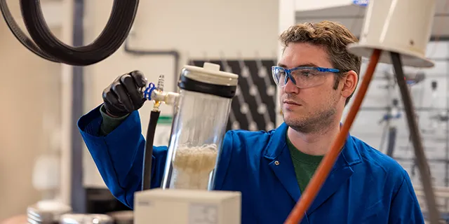 Master of toxicology student at KU performing toxicity testing in a toxicology research lab